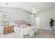Bright and spacious main bedroom with a large bed, soft carpet, and a view into the main bathroom at 1458 Clarendon Way, Mount Pleasant, SC 29466