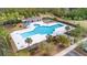 Aerial view of a community pool and recreation area surrounded by palm trees and lounge chairs at 1458 Clarendon Way, Mount Pleasant, SC 29466