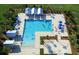 Overhead shot of a community pool with various seating, umbrellas, and palm trees at 146 Brant Dr, Summerville, SC 29483