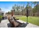 Inviting back patio with stylish outdoor furniture and a peaceful view of the expansive, well-maintained lawn at 146 Brant Dr, Summerville, SC 29483
