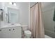 Bright bathroom with white cabinets, toilet, and shower/tub combo with a neutral-colored curtain at 146 Brant Dr, Summerville, SC 29483