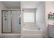 Bathroom showcasing glass shower, soaking tub, and vanity with modern fixtures and bright lighting at 146 Brant Dr, Summerville, SC 29483