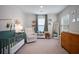 Charming Bedroom with a crib, cozy chair, and a decorative display of books and stuffed animals at 146 Brant Dr, Summerville, SC 29483