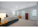 Bedroom features natural light, neutral paint, carpet, and complementing furnishings with a door to the outside at 146 Brant Dr, Summerville, SC 29483