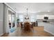Charming dining room with a sliding glass door, wooden table, and modern chandelier at 146 Brant Dr, Summerville, SC 29483