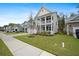 Two-story home featuring a welcoming front porch, well-manicured lawn, and easy access to the sidewalk at 146 Brant Dr, Summerville, SC 29483