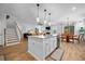 Bright open concept kitchen with island seating and open to the living and dining area at 146 Brant Dr, Summerville, SC 29483