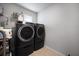 Laundry room showcasing modern washer and dryer units with convenient shelving at 146 Brant Dr, Summerville, SC 29483