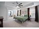 Large bedroom with a king-sized bed, tray ceiling, and stylish decor with large windows at 146 Brant Dr, Summerville, SC 29483