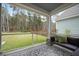 Enclosed Patio showcasing backyard views, privacy fence, swing and complementing furnishings at 146 Brant Dr, Summerville, SC 29483
