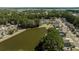 Panoramic aerial view of a residential area bordering a pond, with lush trees providing a serene backdrop at 1465 Water Edge Dr, Charleston, SC 29492