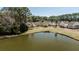 Scenic aerial view of a pond surrounded by lush greenery in a quiet residential neighborhood at 1465 Water Edge Dr, Charleston, SC 29492