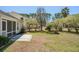 Relax in this backyard featuring a patio, lush lawn, mature trees, and outdoor fire pit for entertaining at 1465 Water Edge Dr, Charleston, SC 29492
