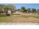 Enjoy this backyard with views of the lake, mature trees, a stone fire pit, and a well-maintained lawn at 1465 Water Edge Dr, Charleston, SC 29492