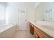 The bathroom features double sinks, a soaking tub, and neutral tiles at 1465 Water Edge Dr, Charleston, SC 29492