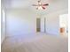 The bright bedroom includes a ceiling fan, large windows, and an open doorway to the bath at 1465 Water Edge Dr, Charleston, SC 29492