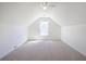Attic bedroom featuring neutral carpet, sloped ceilings, and a window at 1465 Water Edge Dr, Charleston, SC 29492