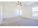Spacious bedroom features a ceiling fan and large windows with a view at 1465 Water Edge Dr, Charleston, SC 29492