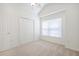 Well-lit bedroom with carpeted floors, double closet, and a window for natural light at 1465 Water Edge Dr, Charleston, SC 29492