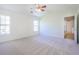 Bright bedroom features ceiling fan and large windows filling the space with natural light at 1465 Water Edge Dr, Charleston, SC 29492
