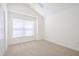 Bright bedroom featuring neutral carpet, a large window, and a ceiling fan at 1465 Water Edge Dr, Charleston, SC 29492