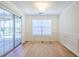 Bright dining room features wainscoting, wood floors, and sliding doors to the porch at 1465 Water Edge Dr, Charleston, SC 29492