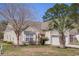 Attractive home with a well-kept lawn, mature trees, and an attached garage on a sunny day at 1465 Water Edge Dr, Charleston, SC 29492