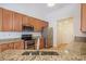 Beautifully appointed kitchen features granite countertops, stainless steel appliances, and hardwood floors at 1465 Water Edge Dr, Charleston, SC 29492
