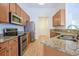 Spacious kitchen boasts granite countertops, stainless appliances, ample cabinetry, and hardwood flooring at 1465 Water Edge Dr, Charleston, SC 29492