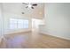 Bright and airy living room features hardwood floors, a ceiling fan, and large window with natural light at 1465 Water Edge Dr, Charleston, SC 29492