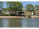 Bask in the scenery of the pond and lush greenery from this spacious backyard, perfect for nature lovers at 1465 Water Edge Dr, Charleston, SC 29492