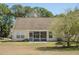This home features a screened porch, a stone fire pit, a well-maintained lawn and mature landscaping at 1465 Water Edge Dr, Charleston, SC 29492