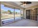 View of the beautiful lake from this screened porch, which features a ceiling fan and access to the backyard at 1465 Water Edge Dr, Charleston, SC 29492
