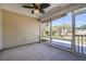 Enjoy this screened porch with a ceiling fan and peaceful view of the backyard and outdoor fire pit at 1465 Water Edge Dr, Charleston, SC 29492