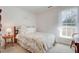 Bright bedroom with a full bed, side table, and window providing natural light at 1530 Fort Johnson Rd # 3C, Charleston, SC 29412