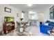 This well-lit living room includes a blue sofa, dining table, and a view into the kitchen area at 1530 Fort Johnson Rd # 3C, Charleston, SC 29412