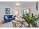 The living room features cozy seating, a glass table and a patio door leading to an outside deck at 1530 Fort Johnson Rd # 3C, Charleston, SC 29412
