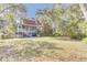 Spacious backyard with mature trees, screened porch and brick house with manicured lawn at 1540 Strathmore Ln, Mount Pleasant, SC 29464