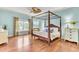 Spacious primary bedroom featuring a four-poster bed, wood floors, and lots of natural light at 1540 Strathmore Ln, Mount Pleasant, SC 29464