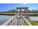 Scenic waterfront dock with gazebo offers a serene retreat amidst lush marshland and picturesque views at 1540 Strathmore Ln, Mount Pleasant, SC 29464