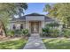 Elegant home exterior featuring manicured landscaping, a stately entrance with columns, and large windows at 1540 Strathmore Ln, Mount Pleasant, SC 29464