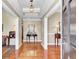 Elegant foyer featuring gleaming hardwood floors, detailed ceiling trim, and stylish decor at 1540 Strathmore Ln, Mount Pleasant, SC 29464