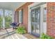 Charming front porch featuring wicker chairs, brick accents, and a welcoming entrance at 1540 Strathmore Ln, Mount Pleasant, SC 29464
