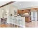 Well-lit kitchen with wooden cabinets, granite countertops, and a breakfast bar with seating at 1540 Strathmore Ln, Mount Pleasant, SC 29464