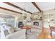 Inviting living room with exposed beams, a brick fireplace, and comfortable seating near a window at 1540 Strathmore Ln, Mount Pleasant, SC 29464