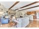 Open-concept living space featuring a brick fireplace, wood beams, and seamless transition to the kitchen at 1540 Strathmore Ln, Mount Pleasant, SC 29464