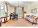 Bright living room featuring a grand piano, chandelier, and comfortable seating near large windows at 1540 Strathmore Ln, Mount Pleasant, SC 29464