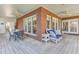 Covered patio with brick accents, ceiling fans, and outdoor seating at 1540 Strathmore Ln, Mount Pleasant, SC 29464