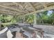 Covered outdoor patio with wooden picnic tables offers an inviting space for relaxation and entertainment at 1540 Strathmore Ln, Mount Pleasant, SC 29464