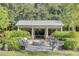 Outdoor fire pit and covered pavilion surrounded by chairs, shrubs, and trees at 1540 Strathmore Ln, Mount Pleasant, SC 29464